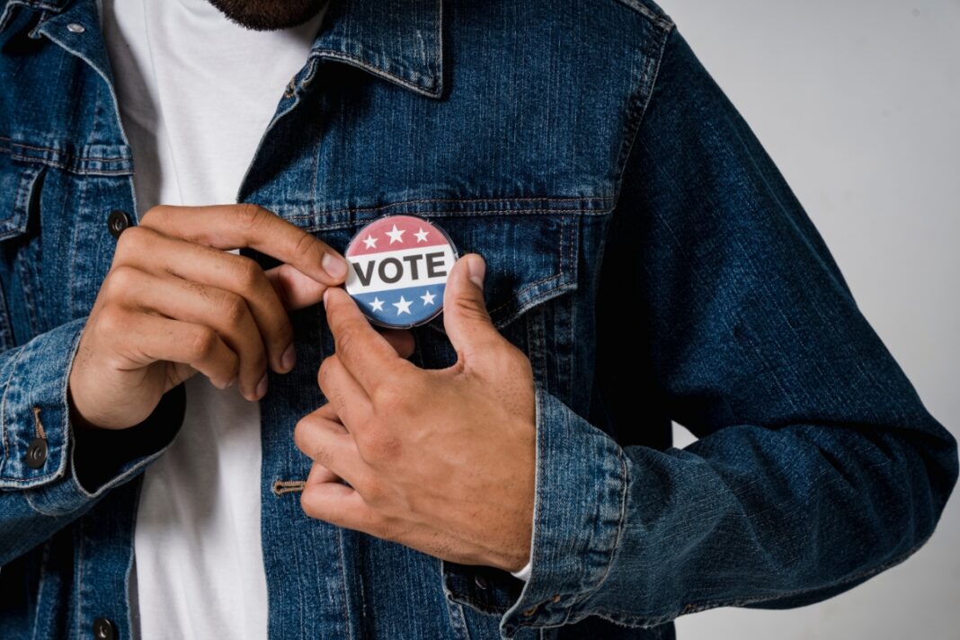 A voter affixes a 