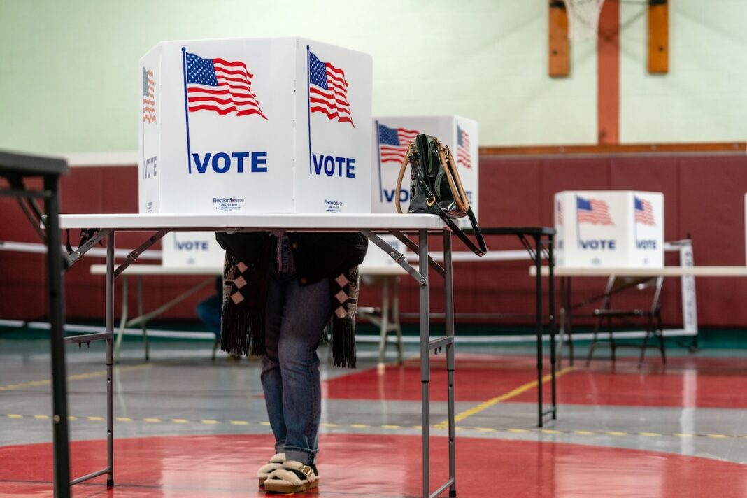 A voter stands in a voting booth at Emily City Hall, Minnesota on Nov. 5, 2024